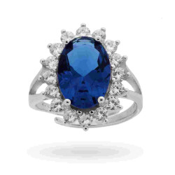ANELLO SOLITARIO A GRIFFE CON ZIRCONE OVALE BLU ZAFFIRO CONTORNATO CON ZIRCONI BIANCHI IN ARGENTO 925 RODIATO